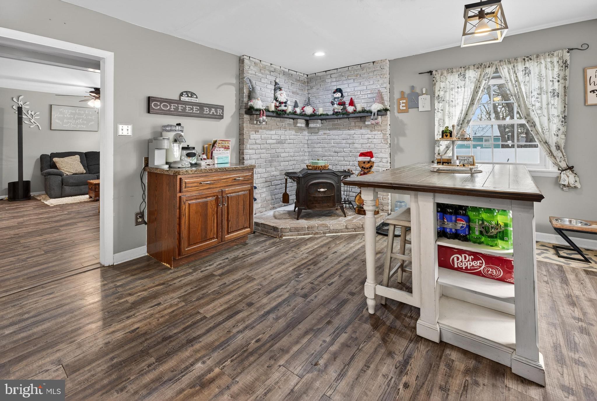 115 South Walnut Avenue Maple Shade, NJ 08052 - Photo 15 of 30 a kitchen with stainless steel appliances granite countertop a stove top oven a sink dishwasher and a dining table with wooden floor