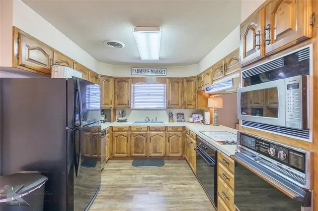 a kitchen with a stove a sink and a refrigerator
