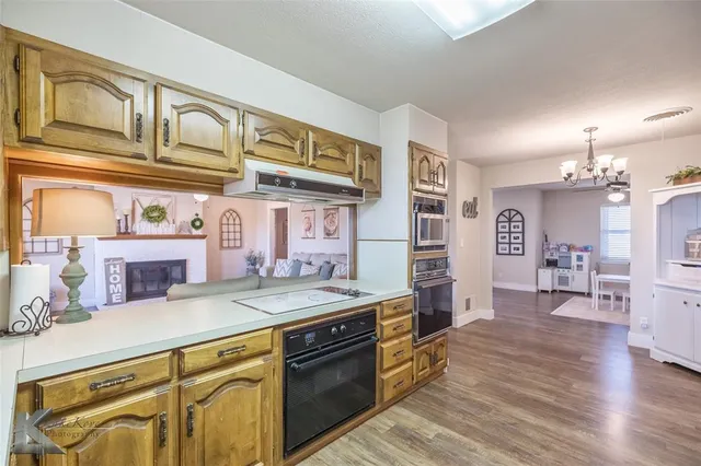 a kitchen with stainless steel appliances granite countertop a sink and cabinets
