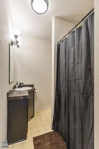 a bathroom with a granite countertop sink and mirror
