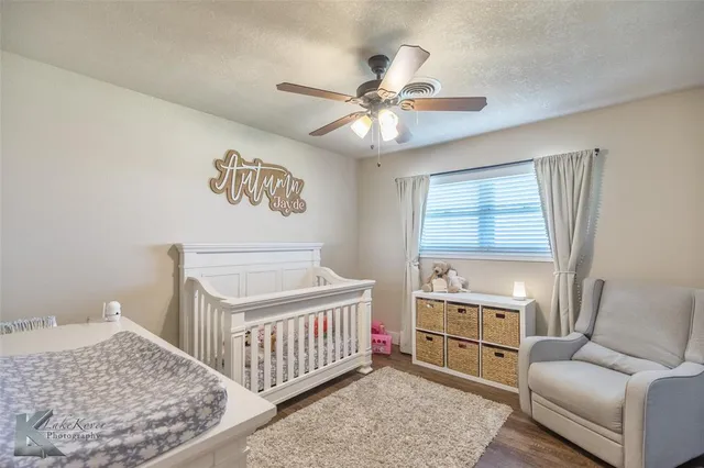 a living room with furniture and a ceiling fan