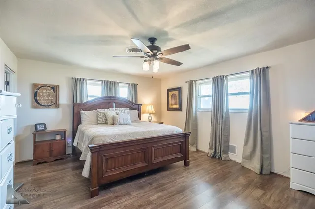 a bathroom with a granite countertop sink mirror and toilet