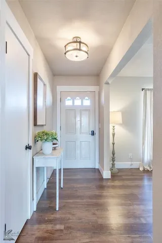 a view of an entryway with wooden floor