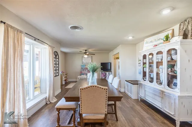 a view of a dining room with furniture window and wooden floor
