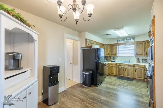 a kitchen with a refrigerator and a sink