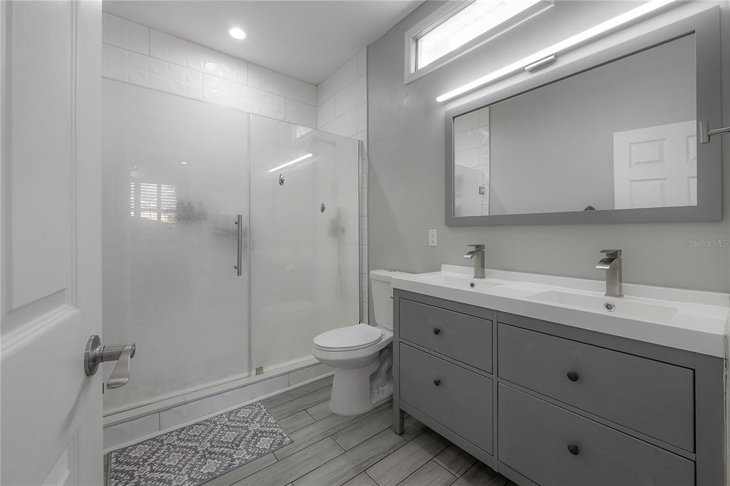 2341 West Chestnut Street Tampa, FL 33607 - Photo 18 of 42 a bathroom with a double vanity sink toilet and shower