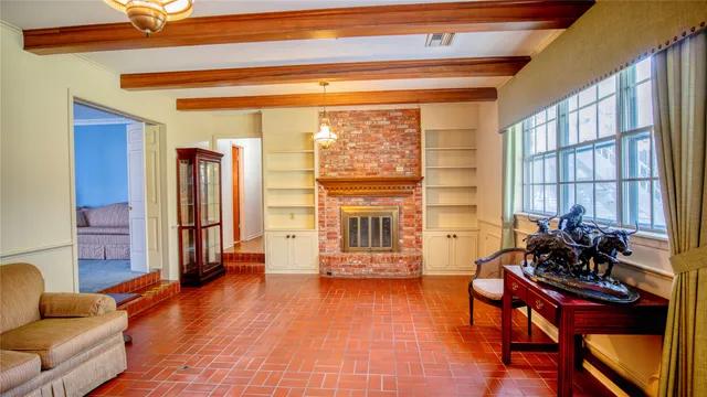 a living room with furniture and a floor to ceiling window