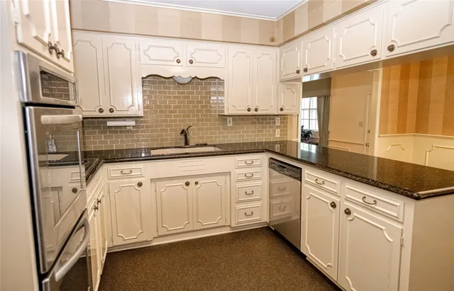 a kitchen with stainless steel appliances cabinets and a counter top space