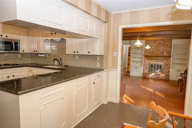 a kitchen with granite countertop a sink and a stove