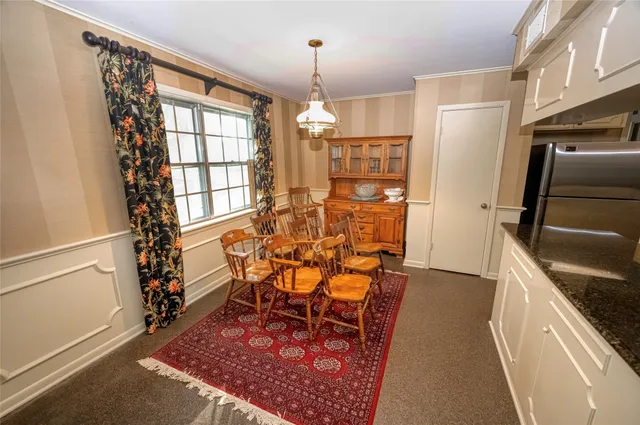 a kitchen with granite countertop a refrigerator and a sink