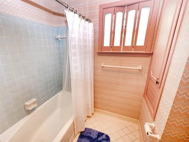 a bathroom with bathtub and shower