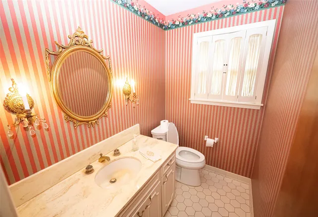 a bathroom with a sink a toilet and a mirror