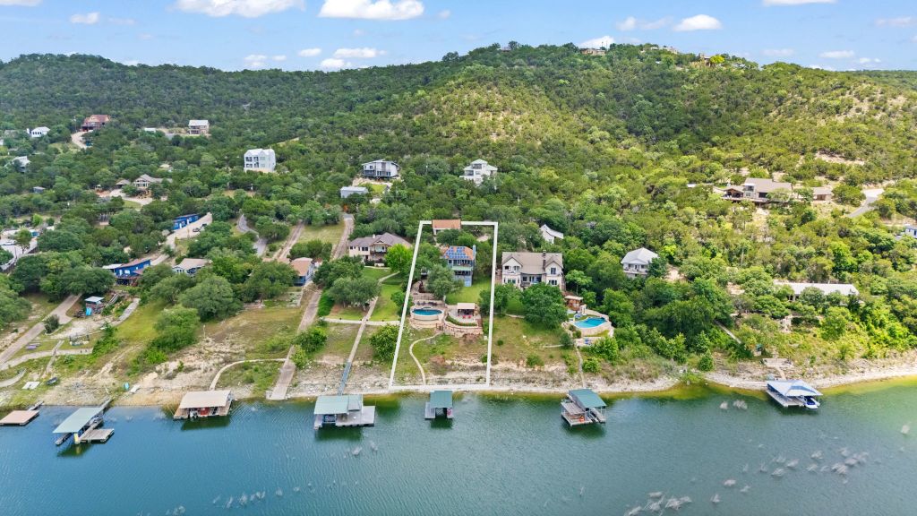 10800 Beach Road Leander, TX 78641 - Photo 37 of 39 Perched on a verdant hillside, this waterfront retreat offers private boat slips and a sparkling pool overlooking the lake.