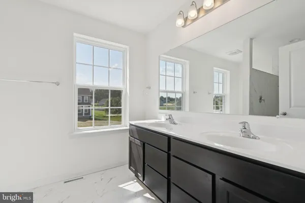 a bathroom with a sink and a window