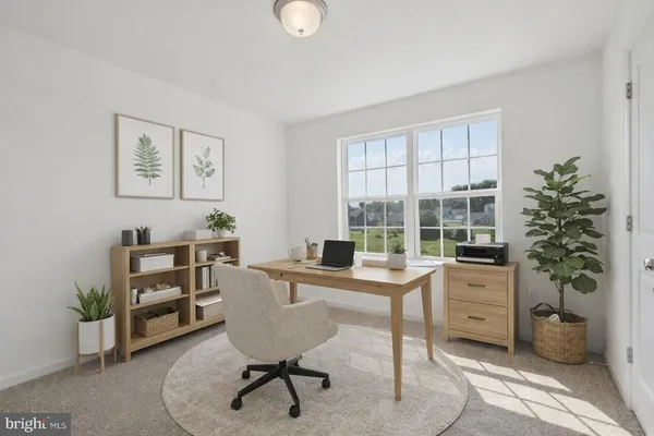 a view of a workspace with furniture and a window
