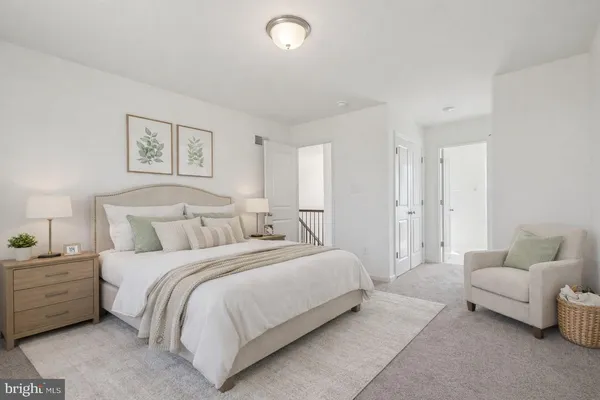 a spacious bedroom with a bed and a couch