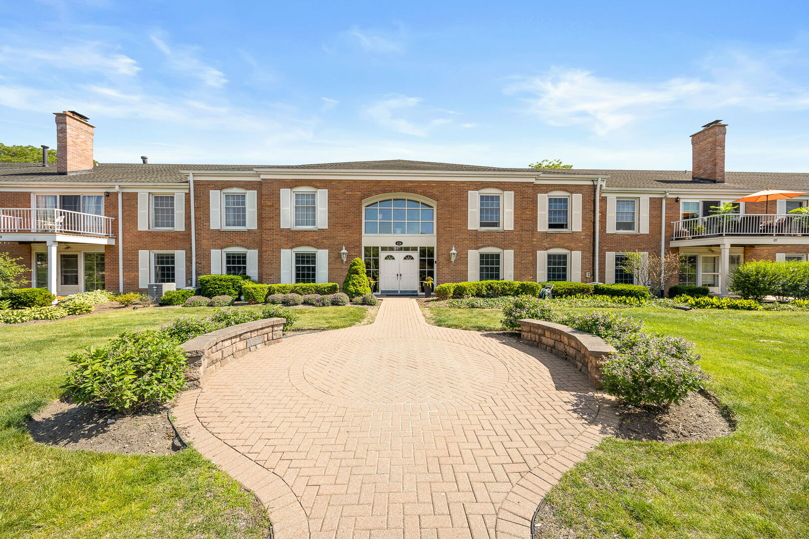 124 Carriage Way Drive, Unit B109 Burr Ridge, IL 60527 - Photo 1 of 31 a front view of a house with a yard