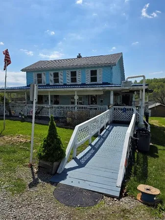 a view of a house with backyard and sitting area