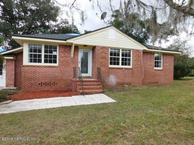 9770 Lily Road Jacksonville, FL 32246 - Photo 1 of 53 a front view of a house with garden