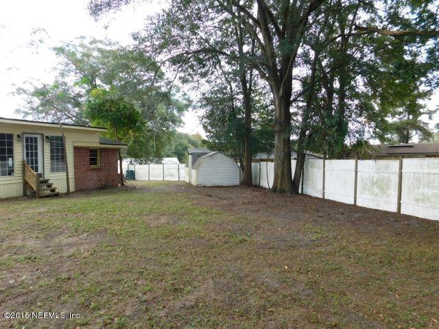 9770 Lily Road Jacksonville, FL 32246 - Photo 17 of 53 a view of a house with a yard and garage