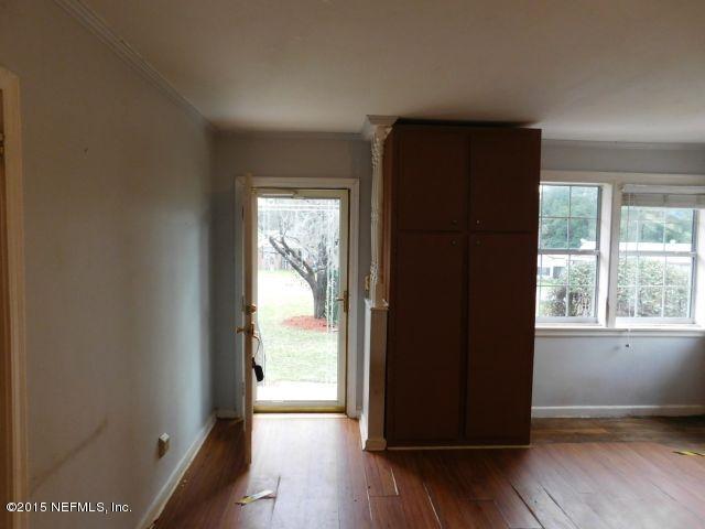 9770 Lily Road Jacksonville, FL 32246 - Photo 22 of 53 an empty room with wooden floor and windows