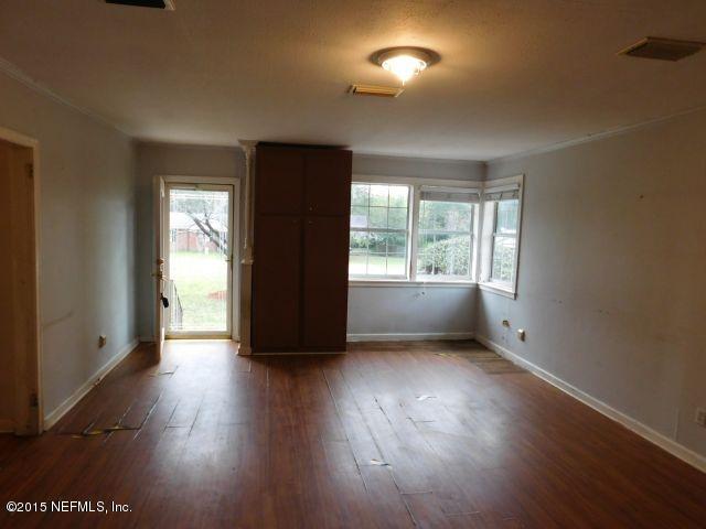 9770 Lily Road Jacksonville, FL 32246 - Photo 23 of 53 an empty room with wooden floor and windows