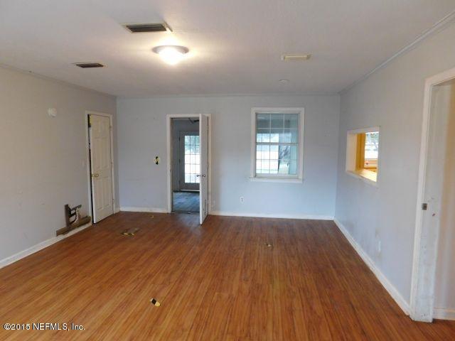 9770 Lily Road Jacksonville, FL 32246 - Photo 24 of 53 a view of an empty room with wooden floor and a window