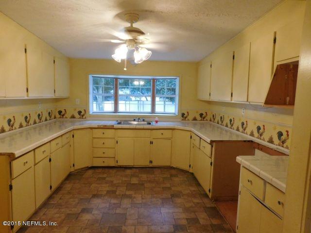 9770 Lily Road Jacksonville, FL 32246 - Photo 28 of 53 a kitchen with sink cabinets and window