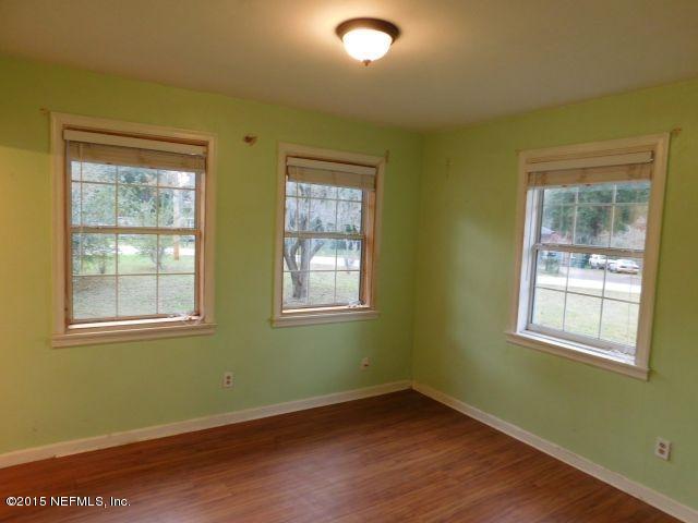 9770 Lily Road Jacksonville, FL 32246 - Photo 35 of 53 a view of an empty room with wooden floor and a window