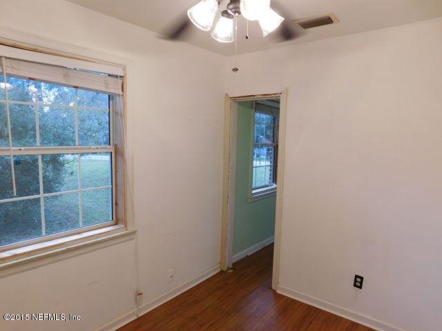 9770 Lily Road Jacksonville, FL 32246 - Photo 38 of 53 an empty room with wooden floor and windows