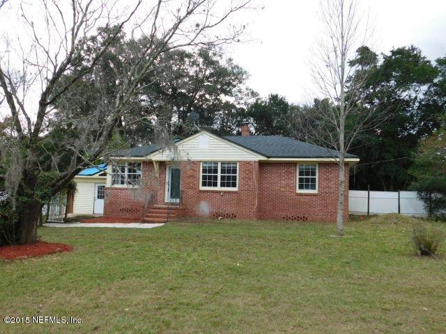 9770 Lily Road Jacksonville, FL 32246 - Photo 4 of 53 a front view of house with yard and trees in the background