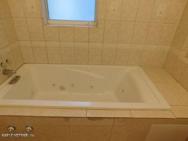 9770 Lily Road Jacksonville, FL 32246 - Photo 42 of 53 a bathroom with a bathtub