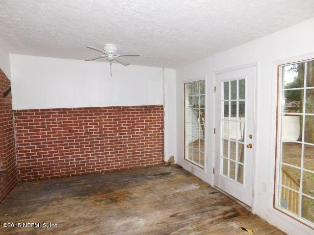 9770 Lily Road Jacksonville, FL 32246 - Photo 49 of 53 a view of a hall with wooden door