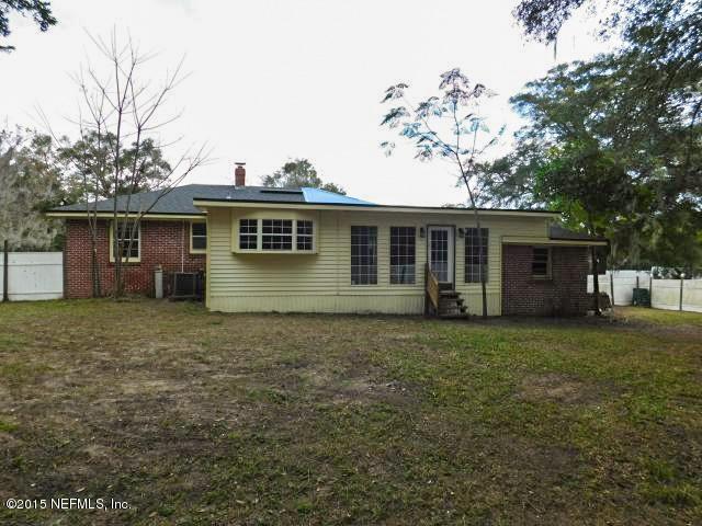 9770 Lily Road Jacksonville, FL 32246 - Photo 7 of 53 front view of a house with a yard