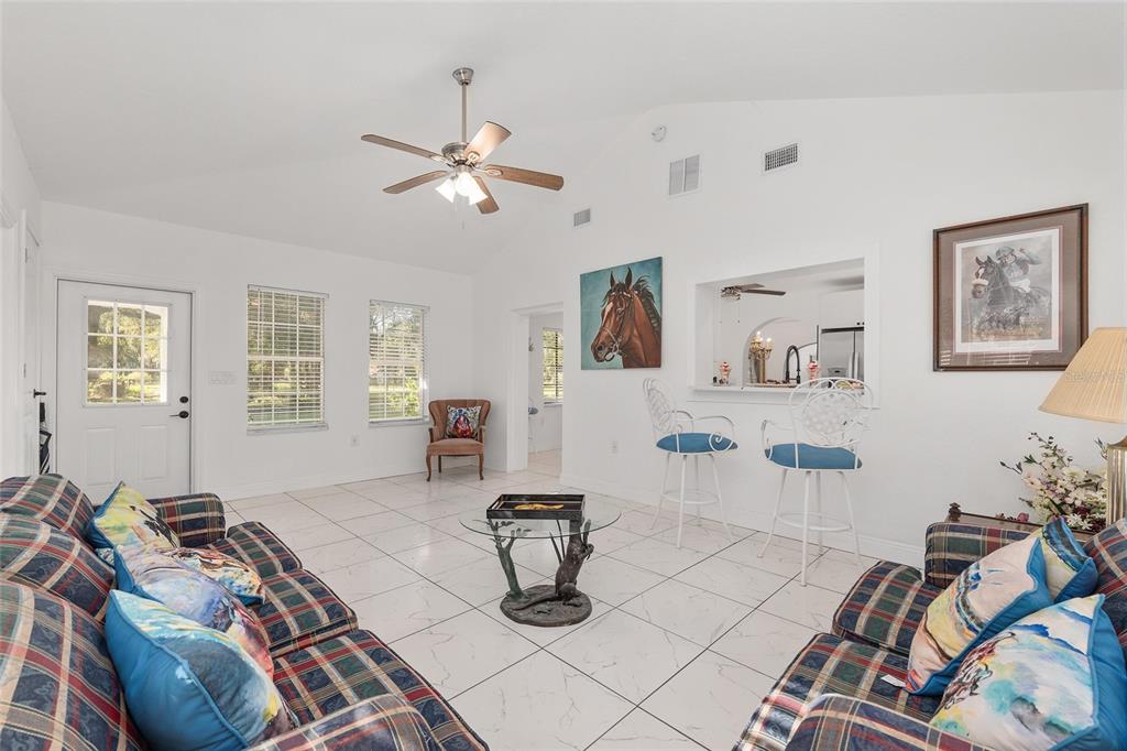 17067 Northwest Gainesville Road Reddick, FL 32686 - Photo 9 of 25 a living room with furniture a dining table and white walls
