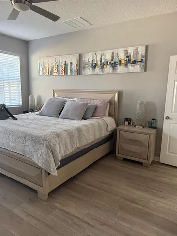 a bedroom with a bed and a window