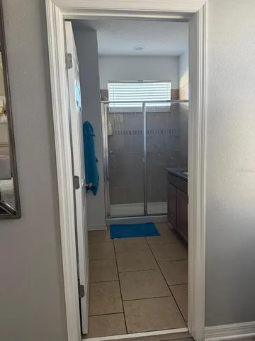 a bathroom with a glass shower door