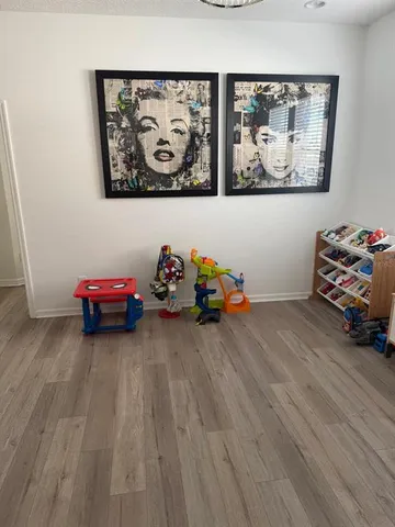 a view of a room with toys and wooden floor