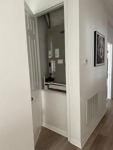 a view of a hallway with wooden floor