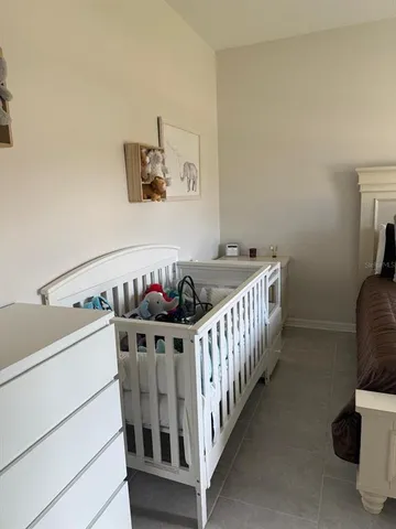 a bedroom with furniture and a baby crib