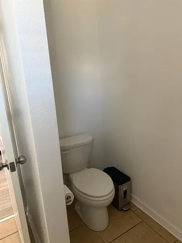 a white toilet sitting next to a sink