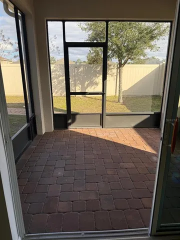 a view of an empty room and a window