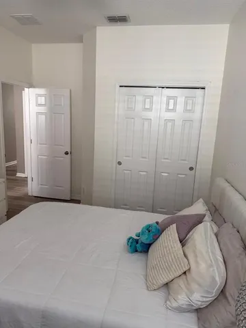 a bedroom with furniture and a potted plant