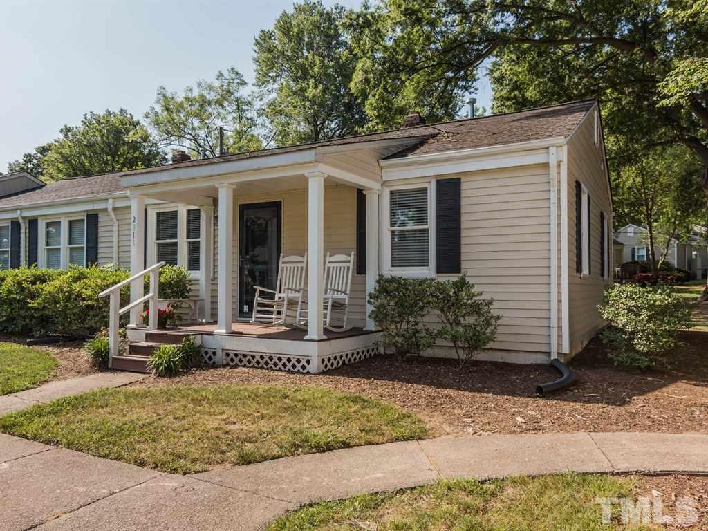 2311 Bernard Street, Unit 2311 Raleigh, NC 27608 - Photo 22 of 24 a view of a house with small yard plants and large tree