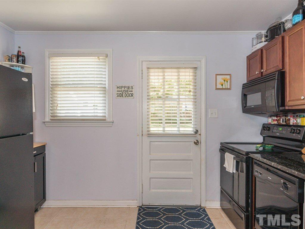 2311 Bernard Street, Unit 2311 Raleigh, NC 27608 - Photo 8 of 24 a kitchen with a stove and a microwave