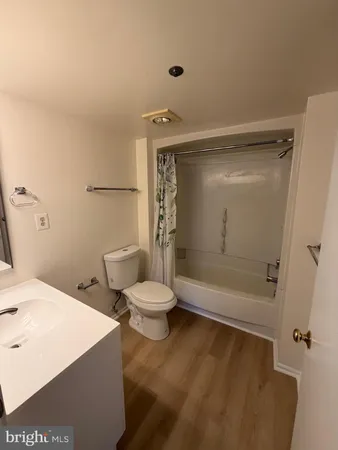 a bathroom with a shower a toilet and a sink