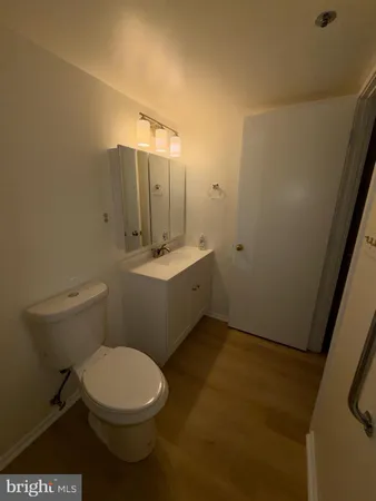 a bathroom with a toilet a sink and mirror