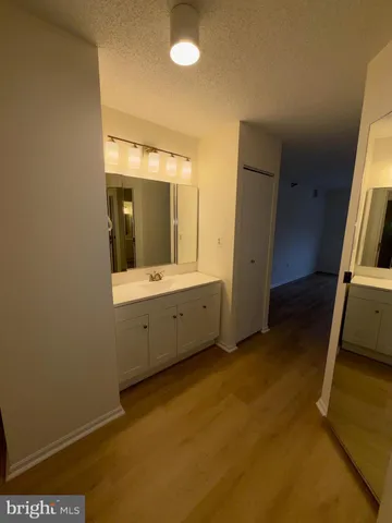 a view of a bathroom with double vanity sink and mirror