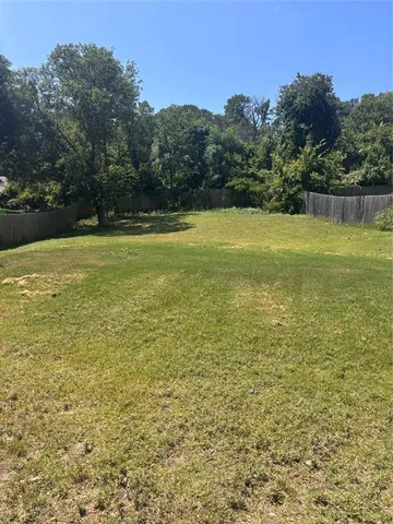 a view of a yard with a house in the background