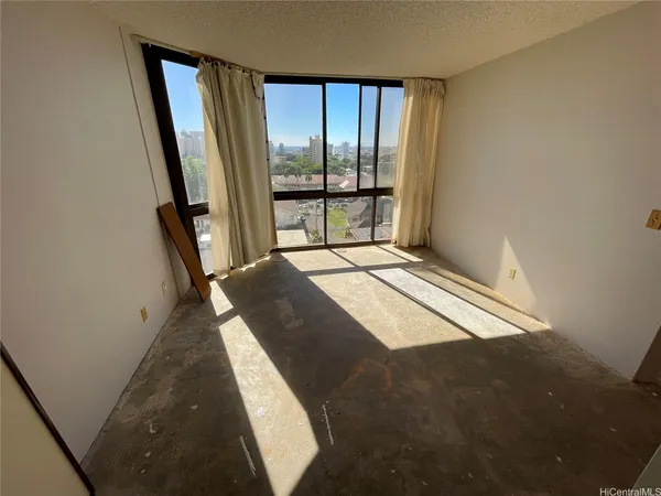 a bedroom with a bed and a large window